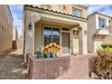 Inviting front porch, stucco exterior, desert landscaping, and an attached one car garage at 9748 Villa Lorena Ave, Las Vegas, NV 89147