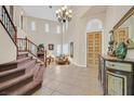 Grand foyer with high ceilings, stairs, tile flooring, and stylish decor at 10001 Blairwood Ct, Las Vegas, NV 89178