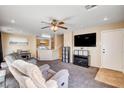 Inviting living room showcasing an open layout, neutral tones, and a ceiling fan at 10066 Delicate Dew St, Las Vegas, NV 89183