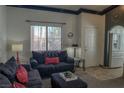 Cozy living room featuring a neutral color palette, comfortable seating, and a large front window at 10553 Pine Pointe Ave # 201, Las Vegas, NV 89144
