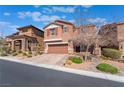Attractive two story home with a two car garage, desert landscaping, and a paved driveway at 10568 Pelican Island Ave, Las Vegas, NV 89166