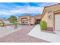 Beautifully landscaped front yard leading to a well-maintained home with a tile roof and two-car garage at 10917 Mcneese Ct, Las Vegas, NV 89134