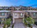 This is an aerial view of a charming two-story home featuring an attached garage and mountain views at 12521 Lylan Ridge St, Las Vegas, NV 89138