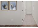 Bright entryway features neutral paint, tile flooring and artwork at 12521 Lylan Ridge St, Las Vegas, NV 89138