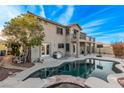 Resort-style backyard with sparkling pool, spa, covered patio, and ample space for outdoor entertaining at 1436 Via Merano St, Henderson, NV 89052