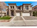 Charming home featuring a stone entryway, three-car garage, and landscaped front yard at 1436 Via Merano St, Henderson, NV 89052