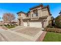 Elegant two-story home showcasing a well-manicured lawn and a three-car garage at 1436 Via Merano St, Henderson, NV 89052