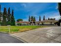 A spacious, well-manicured lawn and long driveway complement this one-story home's exterior at 208 Stonewood, Las Vegas, NV 89107
