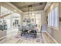 Formal dining room with a modern chandelier, neutral color palette, and views into the entryway and living room at 2737 Josephine Dr, Henderson, NV 89044