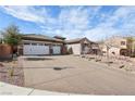 Well-maintained home with a two-car garage, patterned driveway, and attractive landscaping at 2809 Proust Ct, Henderson, NV 89044