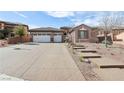 Inviting home with a two-car garage, decorative driveway, and landscaped yard with stepping stones at 2809 Proust Ct, Henderson, NV 89044