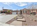 Attractive home with a two-car garage, decorative driveway, and stepping stones leading to the entrance at 2809 Proust Ct, Henderson, NV 89044