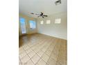 Spacious living room with tile flooring, bright windows, and a modern ceiling fan at 3661 Hammock St, Las Vegas, NV 89147