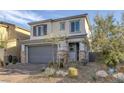 Charming two-story home with a two-car garage and desert landscaping at 3771 Bright Aquarius Ln, Henderson, NV 89052