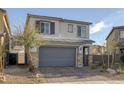 Charming two-story home with a two-car garage and desert landscaping in a suburban neighborhood at 3771 Bright Aquarius Ln, Henderson, NV 89052