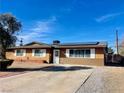 Single story home featuring solar panels, a spacious driveway, and a desert landscaped yard at 3856 Commanche Ave, Las Vegas, NV 89121