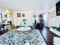 View of living room leading to the dining area with hardwood floors, elegant vintage furniture, and area rug at 3856 Commanche Ave, Las Vegas, NV 89121