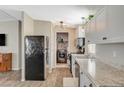 Galley kitchen with stainless steel appliances, gray and white countertops, and bright white cabinets at 425 Bonelli Ave, Overton, NV 89040