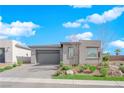 A single-story home showcases a paved driveway, desert landscaping, and a two-car garage at 5095 E Long Leaf Ct, Pahrump, NV 89061