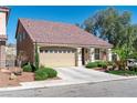 Charming single-story home with a well-maintained lawn and a private driveway, featuring a tile roof at 5350 Tulip Hill Ave, Las Vegas, NV 89141