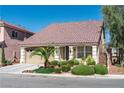 Inviting single-story home with lush landscaping, manicured shrubbery, and a spacious two-car garage at 5350 Tulip Hill Ave, Las Vegas, NV 89141