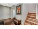 Inviting foyer featuring hardwood floors, staircase, and stylish decor at 7018 Hunts Corner St, Las Vegas, NV 89166