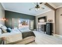 Spacious main bedroom with a ceiling fan, dresser, wall-mounted TV, safe, and French doors to the pool at 720 Camino La Paz, Henderson, NV 89012
