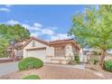 Charming single-story home with a tiled roof, landscaped yard, and gated side entrance at 7608 Sierra Paseo Ln, Las Vegas, NV 89128