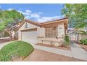 Charming single-story home with a tiled roof, landscaped yard, and gated side entrance at 7608 Sierra Paseo Ln, Las Vegas, NV 89128