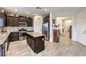 Modern kitchen featuring stainless steel appliances, dark wood cabinets, and a center island at 7948 Eastern Elk St, Las Vegas, NV 89149
