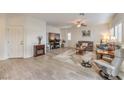 Bright living room with tile flooring, a ceiling fan, and large windows at 7948 Eastern Elk St, Las Vegas, NV 89149