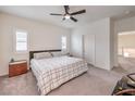 Bedroom with carpeted floors, ceiling fan, and a comfortable plaid-covered bed at 7948 Eastern Elk St, Las Vegas, NV 89149