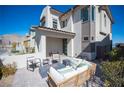 Relaxing outdoor patio with stylish seating, a fire pit, and views of the home at 828 Parker Mesa St, Las Vegas, NV 89138