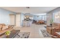 Open-concept living space featuring tile floors, comfortable seating, and a modern kitchen island at 929 Sulphur Springs Ln # 102, Las Vegas, NV 89128