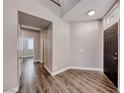 Bright entryway featuring wood-look flooring, neutral walls, and a view of the staircase and hallways at 9505 Belgate Ct, Las Vegas, NV 89129