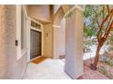 Covered front porch featuring a stylish entrance door, textured columns, and well-maintained surroundings at 9505 Belgate Ct, Las Vegas, NV 89129