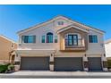 Multi-level townhome featuring private garages and a small balcony, with neutral stucco and tile roof at 10107 Sunset Palisades Way # 103, Las Vegas, NV 89183