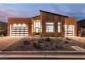 Stunning home exterior with two garage doors and xeriscaping, complemented by a modern architectural design at 10739 Agate Cliffs Ave, Las Vegas, NV 89135