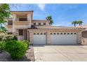 Two-story home featuring a three-car garage, light-colored exterior, and a sunny sky at 1339 Echo Creek St, Henderson, NV 89052