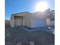 Front exterior of a single story beige colored home, concrete driveway, small front yard at 2100 Fred Brown Dr, Las Vegas, NV 89106