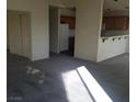 Open-concept living space with carpet that leads into the kitchen area with a breakfast bar at 227 Big Horn Dr, Boulder City, NV 89005