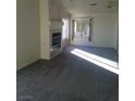 Bright living room with carpet, natural light, fireplace, and a ceiling fan at 227 Big Horn Dr, Boulder City, NV 89005