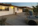Image showing the backyard with a concrete patio, light fixture and an overhanging roof at 2564 San Marcos St, Las Vegas, NV 89115