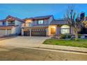 Charming two-story home with desert landscaping, three-car garage, and a tiled roof set at dusk at 2813 Via Avanti St, Henderson, NV 89074