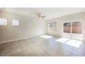 Large open living space with tile flooring, ceiling fan and slider door access to the backyard at 3747 Lambent Ave, North Las Vegas, NV 89084