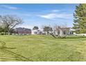 A sprawling property with a large green lawn and elegant white home featuring arched windows at 3938 E Russell Rd, Las Vegas, NV 89120