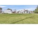 Expansive home with a large lawn, architectural details, and mature landscaping at 3938 E Russell Rd, Las Vegas, NV 89120