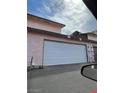 Attached garage with a white door on an exterior view of the building at 4363 Spencer St # 8, Las Vegas, NV 89119