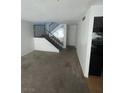 View of the living room and stairs with black metal railing leading to the second floor at 4363 Spencer St # 8, Las Vegas, NV 89119