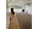 Spacious living room featuring neutral carpet, a fireplace, vaulted ceilings, and natural light at 4508 W San Miguel Ave, North Las Vegas, NV 89032